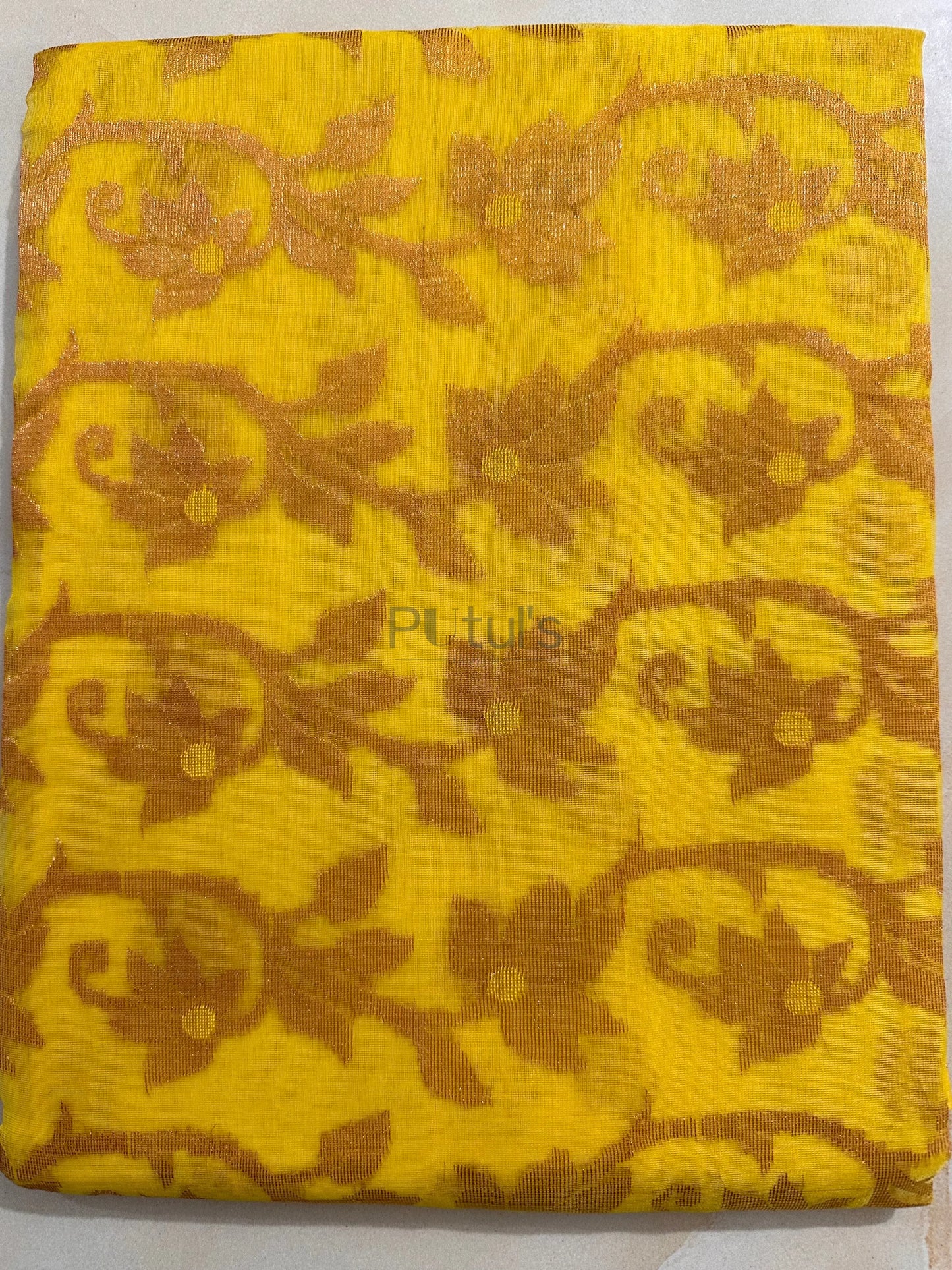 Yellow coloured Muslin saree of golden meenakari work Putul's Fashion