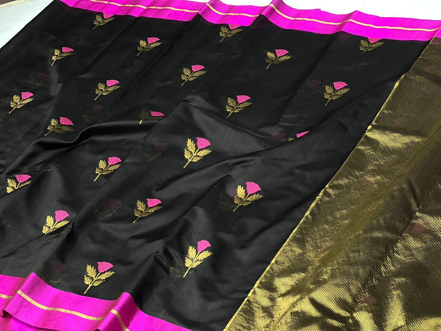 Black coloured pattu silk enriched with rich hand weave minakari work