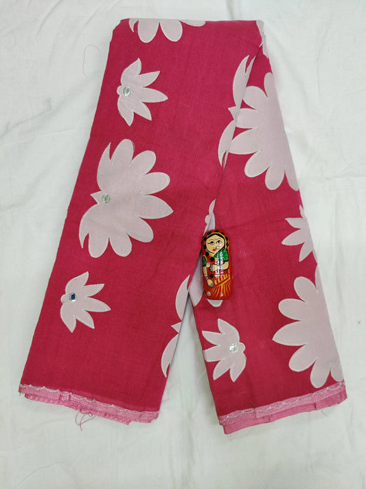 A saree with a floral applique design. The saree is made of silk and is soft and luxurious to wear. The floral applique design is made of intricate threadwork and adds a touch of elegance to the saree. The saree is perfect for a formal or informal event.