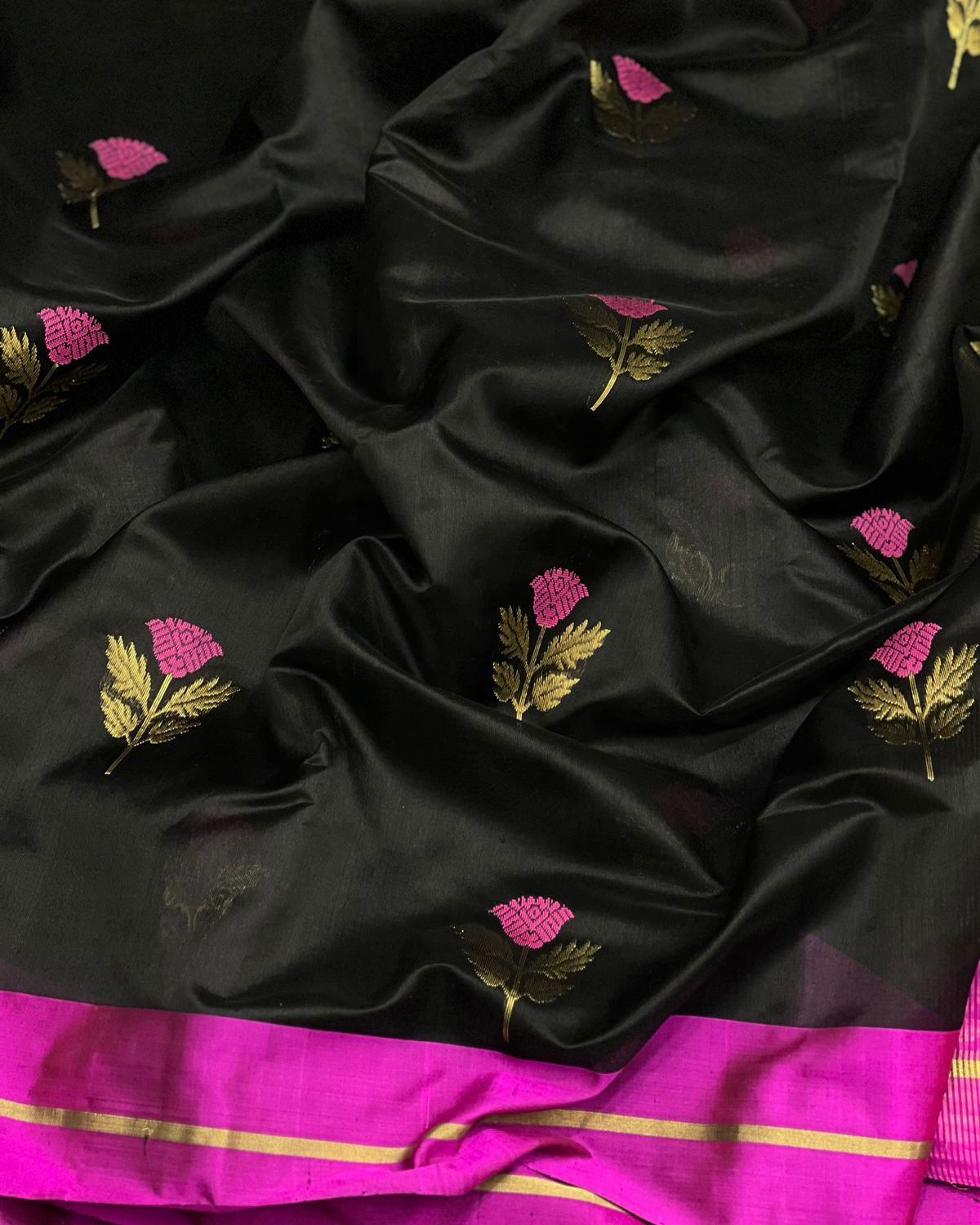 Black coloured pattu silk enriched with rich hand weave minakari work