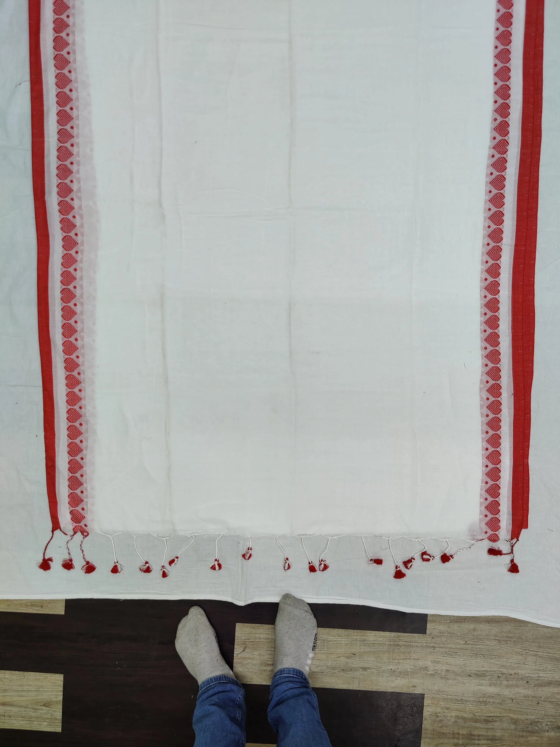 The saree is a beautiful shade of white. The saree is made of 100% cotton. The saree is soft and comfortable to wear. The saree is perfect for a formal or informal event. Putul's fashion